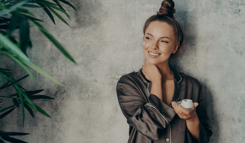 Woman holding a jar of sleeping mask skincare treatment